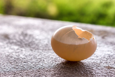 Close-up of broken egg on table