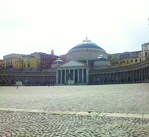 Buildings in city against clear sky