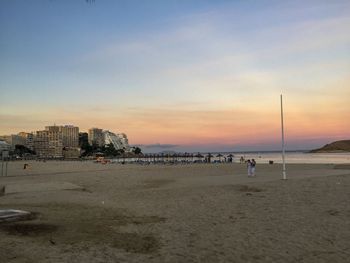 Scenic view of beach against sky during sunset