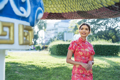 Happy chinese new year. asian woman wearing traditional cheongsam qipao dress.