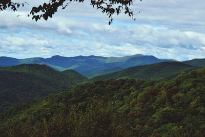 Scenic view of mountains against cloudy sky