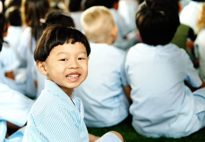 Portrait of smiling boy sitting in classroom