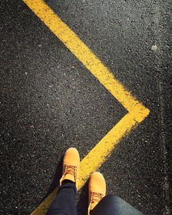 Low section of person walking on road