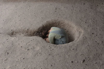 High angle view of girl lying on sand