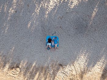 High angle view of people on sand at beach