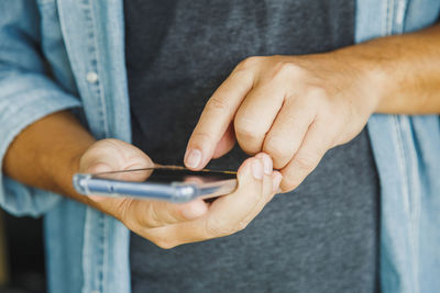 Close up a man holding a texting message chatting with a friend with a mobile phone