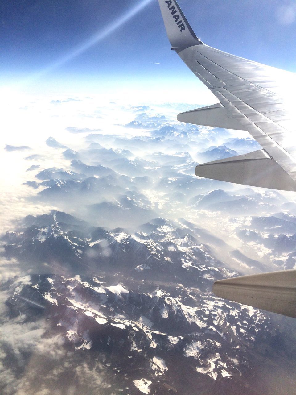 aircraft wing, airplane, air vehicle, flying, aerial view, transportation, cropped, part of, mode of transport, mountain, landscape, scenics, sky, beauty in nature, travel, mid-air, nature, tranquil scene, snow, tranquility