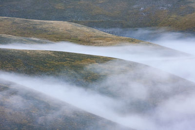 Scenic view of waterfall against sky