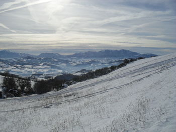 Scenic view of snow covered mountains against sky