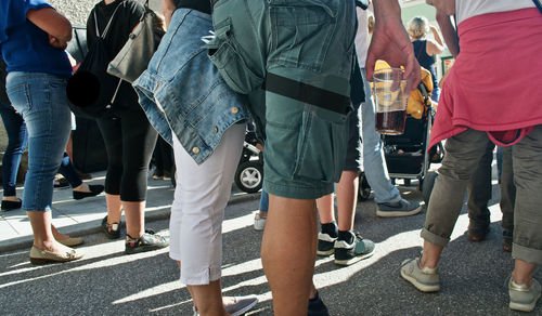 Rear view of people walking on road