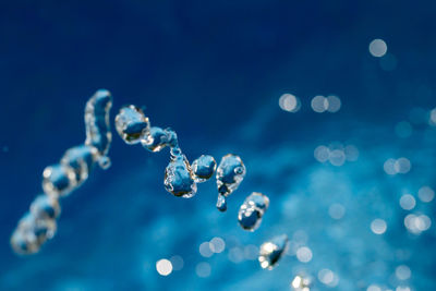 Close-up of bubbles against blue sea