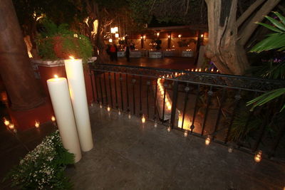 Illuminated candles on table at night