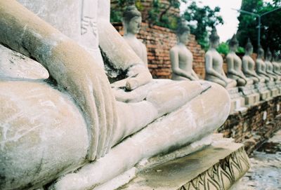 Close-up of statue against historic building