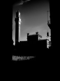 Silhouette buildings against sky in city