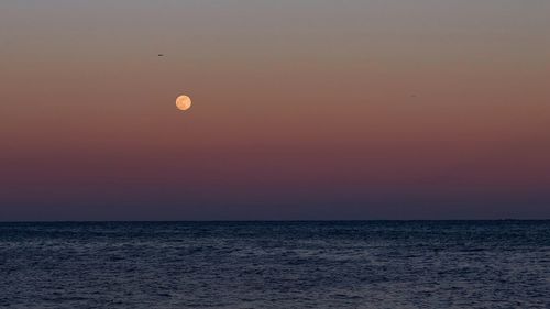 Scenic view of sea against sky at sunset