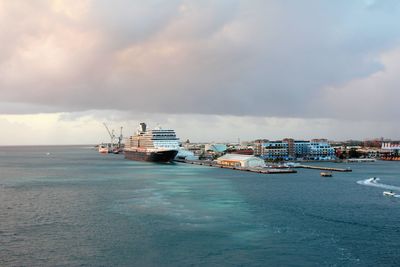 Ship moored at harbor against sky