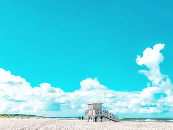 Panoramic view of beach against blue sky