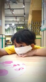 Close-up portrait of girl in table