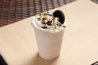 White milkshake with ice cream garnished with cookie.