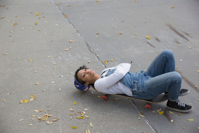 High angle view of man lying on road