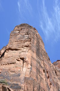 Low angle view of cliff against sky