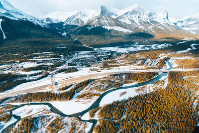 Aerial view of snowcapped mountains against sky