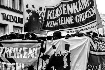 Crowd on street by buildings at may day