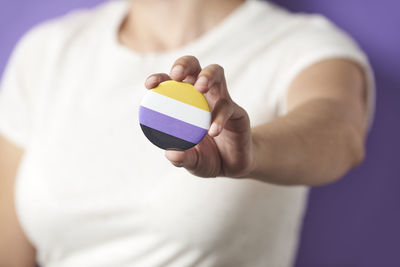 Midsection of man holding pills