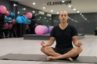 Portrait of young woman exercising at gym