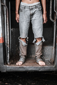 Low section of man standing on road