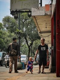 Full length of father with daughter against plants