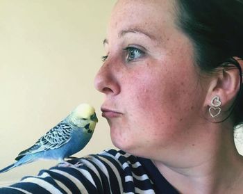 Close-up of young man perching on woman outdoors