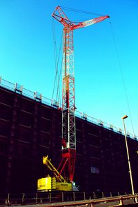 Low angle view of crane against clear sky