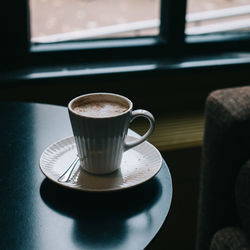 Close-up of coffee cup on table