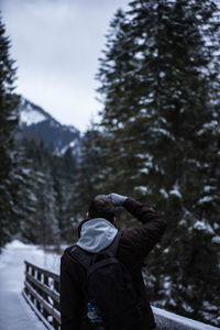 Rear view of man during winter in forest