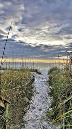 Scenic view of sea against cloudy sky