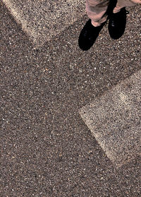 Low section of person standing on road
