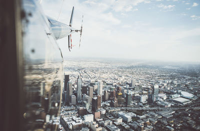 Aerial view of city and buildings against sky