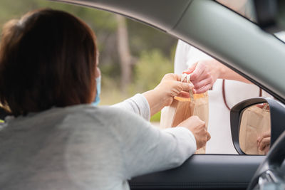 Rear view of woman in car