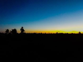 Silhouette landscape against clear sky