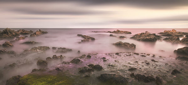 Scenic view of sea against cloudy sky