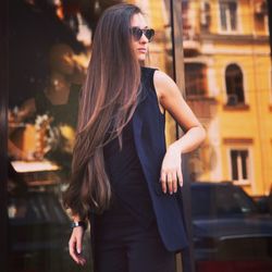 Young woman wearing sunglasses standing outdoors