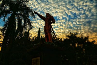 Low angle view of statue against sky during sunset