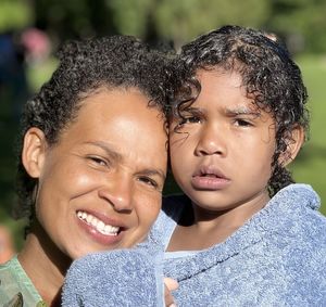 Close-up portrait of smiling mother and daughter 