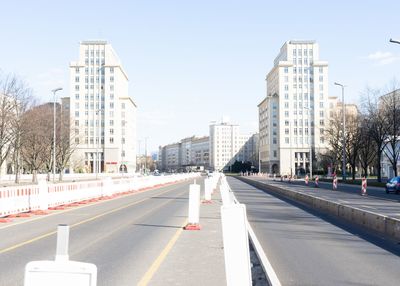 Road by city against sky