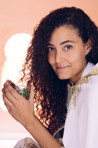 Portrait of smiling woman holding drink