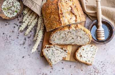 Sliced loaf of artisan sourdough bread with mix seeds. tartine with honey and seeds