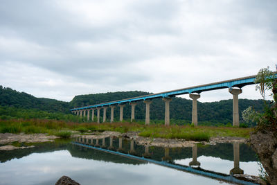 The norman wood bridge over the susquehanna river reflecting itself in a small body of water