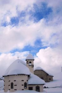 Low angle view of building against cloudy sky