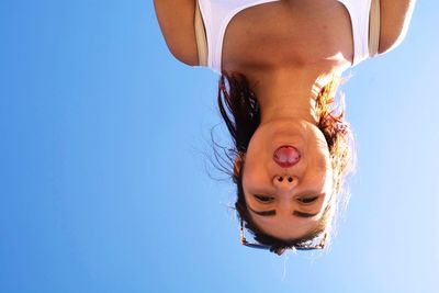 Portrait of woman against clear blue sky